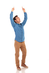 happy casual man celebrating victory with hands in the air