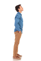 Fototapeta premium side view of a casual young man looking up