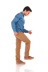 angry young casual man stepping on something