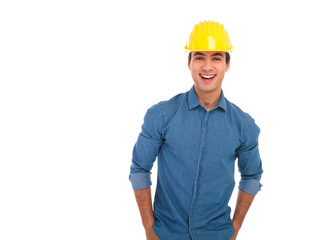 relaxed construction engineer with hands in pockets laughing