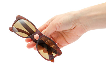 female hand takes or gives sunglasses.