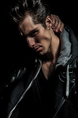 closeup picture of a man holding hand behind his neck