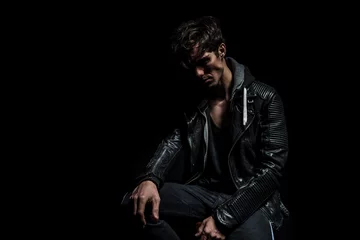 Foto op Plexiglas sad dramatic biker in leather jacket sitting © Viorel Sima