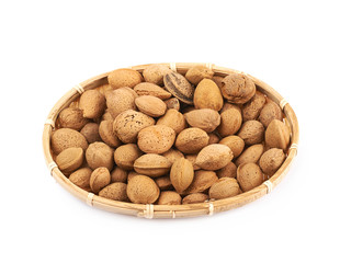 Wicker basket of almond nuts isolated