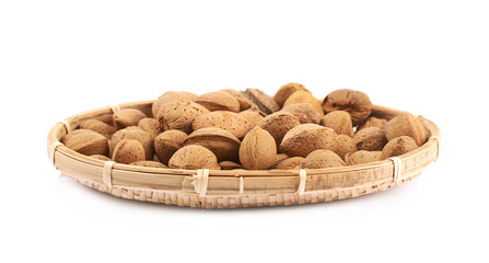 Wicker basket of almond nuts isolated