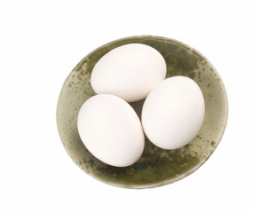 Three eggs in brown bowl