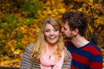Fototapeta premium Lovers couple in autumn park on bench