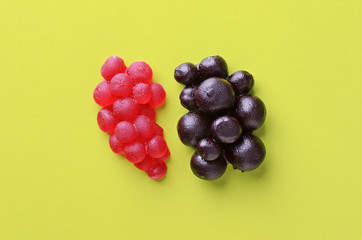 Berries sweet marmalade candy on yellow background