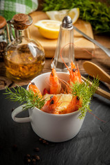 Shrimp in the cup on stone plate.