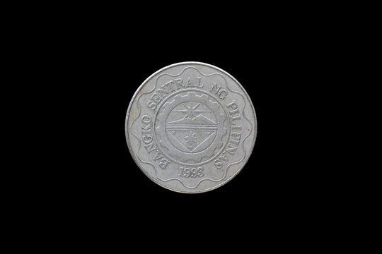 Philippine coins isolated on black background.