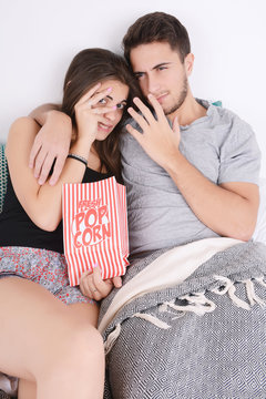 Couple watching movies in bed.