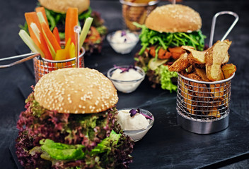 Vegan mushroom burger with salad on a table.