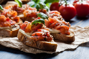 Italian bruschetta with roasted tomatoes, mozzarella cheese and