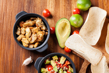 Ingredients ready for preparing chicken tacos with salsa made fr