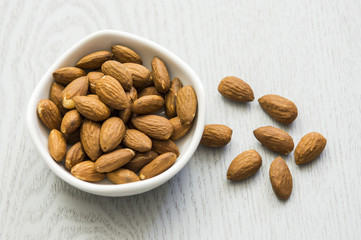 Almonds. Almonds on wooden table. Almonds background. Group of almonds. Peeled almonds. Pile of almonds. Almonds kernel. Almonds nuts.