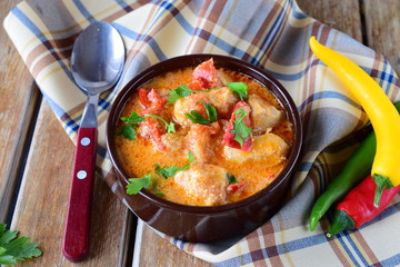 Traditional Hungarian dish witth paprika and chicken in a creamy sause In a ceramic pot. Healthy eating concept