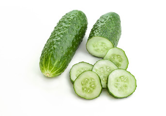 fresh cucumber and slices of cucumber on white background