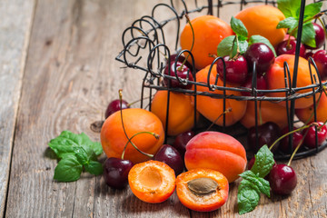  Apricots and cherries on rustic  background