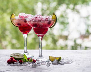 margarita cocktail with lime and raspberries