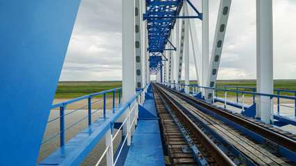 Fototapeta premium Railway bridge across the Yuribey river on the Yamal Peninsula with a length of 3.9 kilometers