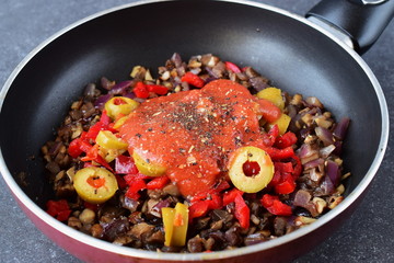 Cooking filling for vegetarian lasagna in rolls with mushrooms, paprika, olives, tomato sauce. Healthy food. Vegetarian food. Step by step cooking