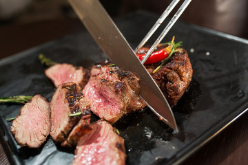 Dinner at the restaurant. Cut meat closeup