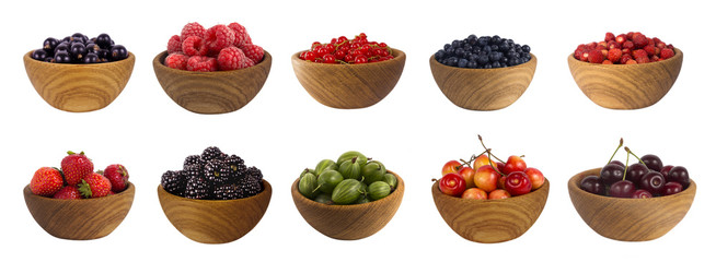 different berries isolated on white background. Collage of fruits and berries: blueberry, blackberry, cherry, strawberry, currant and raspberry. Collection of fruits and berries in a bowl.