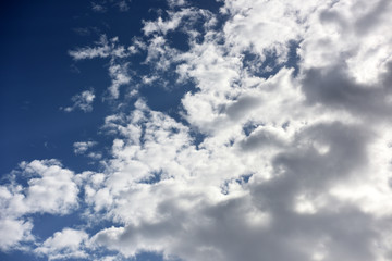 White clouds on dark blue sky