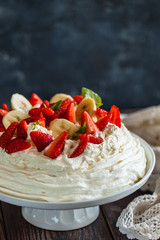 pavlova, meringue cake with strawberries and bananas