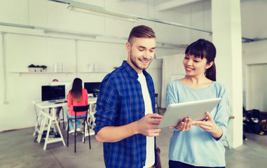 Obraz premium couple with smartphone and tablet pc at office