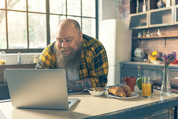 Man using computer in kitchen