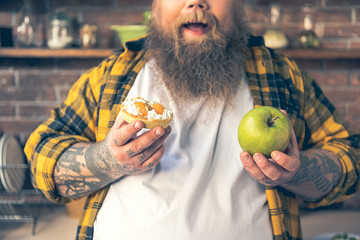 Man hold a dessert and fruit in both hands