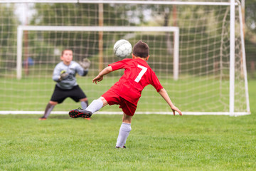 Kids soccer football - children players match on soccer field