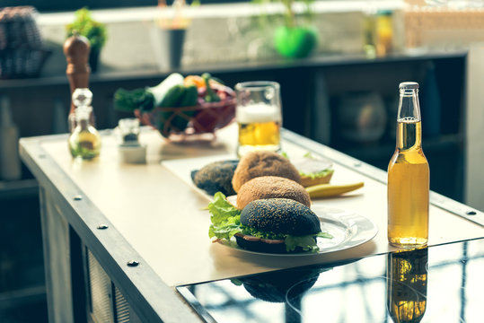 Appetite burgers and alcohol drink on desk
