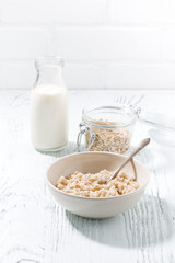 oatmeal and a bottle of milk on white background
