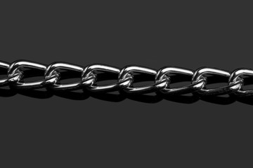 Chain heap - abstract metal background. Collection silver jewelry chains on an isolated black background. Set of different lenght metal chain. Accessories. Bijouterie. Silver.