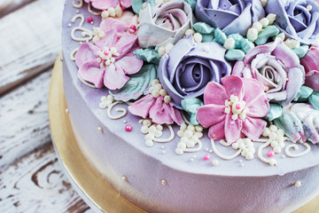 Fototapeta na wymiar Birthday cake with flowers rose on white background