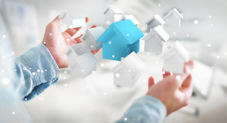 Businessman using 3D rendered small white and blue houses