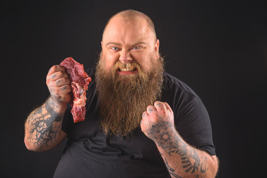 Aggressive Man Holding Meat