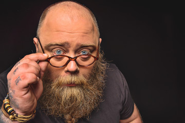 Man with glasses expressing seriousness