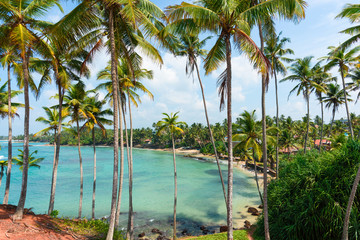 Naklejka na ściany i meble Tropical lagoon with small hotels on the beach