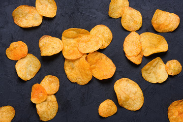 Potato chips on dark background