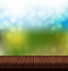 Naklejka na ściany i meble Wood table with summer background. Bright blue and green blur background
