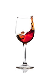Classic Glass of Red Wine isolated on a white background. Splashing red wine in a glass. A splash of red wine in a glass. Grapes. Alcohol.