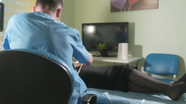 Doctor doing 3d ultrasound on belly of t woman in clinic 4k