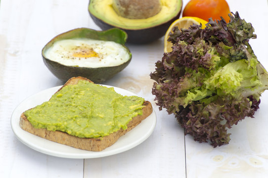 Healthy food. Vegan sandwiches with fresh avocado on wooden background.