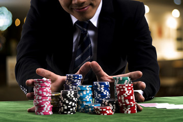 Fototapeta na wymiar A poker Player used hands pushing in all his chips to betting