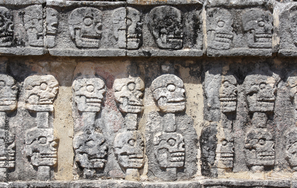 Poster bas-relief carving with human skulls on tzompantli , chichen itza, yucatan, mexico