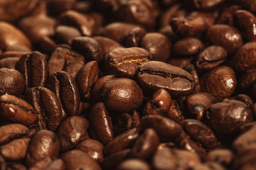 Dark many roasted coffee beans texture background