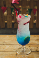 cocktail glass with the Blue Hawaii on wood